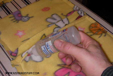 Use Fabric Glue to hold down the fabric lip